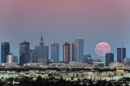 Rising moon over Warsaw city in summer time