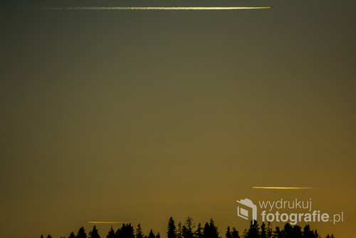 Symetrycznie przelatujące samoloty podczas zachodu słońca.