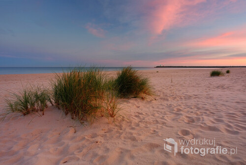 Piękny wschód słońca nad wybrzeżem Morza Bałtyckiego. Plaża w Kołobrzegu, Polska.