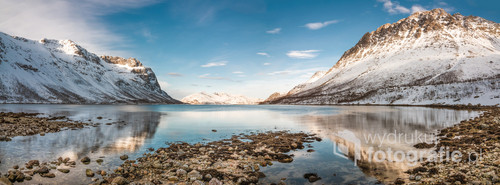 Panoramic view at fjord by the cold sea with snowy peaks in the background Tromso, Norway