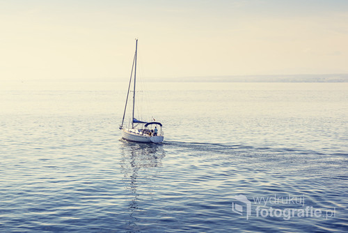 Lonely sailboat on the Constance Lake (Bodensee). Retro filter.