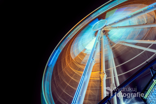 Moving and illuminated ferris wheel, big  wheel on a dark background. 