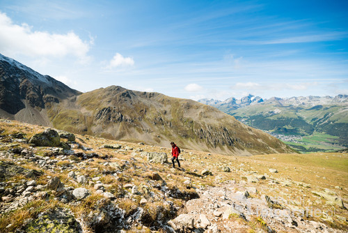 Young hiker walking on the Muragl valley in the area St.Moritz.