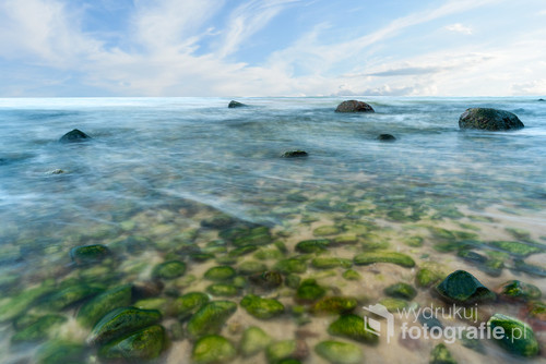A view of the rocky beach in Miedzyzdroje. Baltic sea. Stones into the water. Blurry effect with long exposure.