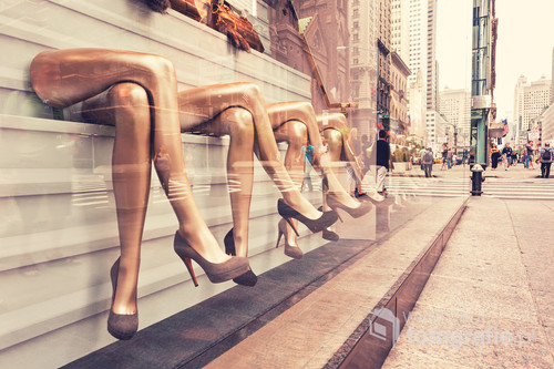Legs of mannequins at the shoe store exhibition. New York city street.