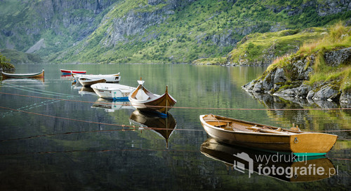 Boats moored on calm water.