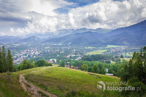 Poland. Polish Tatry mountains. View of the cloudy mountains. In the valley the city of Zakopane.
