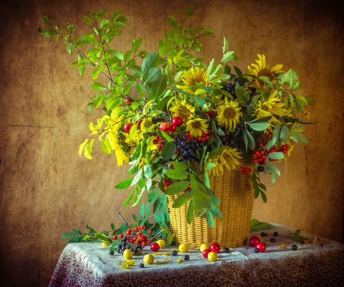 Still life with bouquet of twigs of plum, sunflower, elderberry and rowan